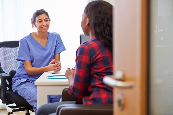 Patient having consultation with young female physician
